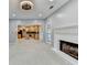 Bright living room featuring a brick fireplace, ceiling fan, and view to the kitchen at 4845 Dartford Dr, Powder Springs, GA 30127