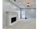 Spacious living room with a painted brick fireplace and large windows at 4845 Dartford Dr, Powder Springs, GA 30127