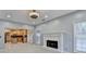 Bright living room featuring a brick fireplace, ceiling fan, and view to the kitchen at 4845 Dartford Dr, Powder Springs, GA 30127