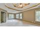 Spacious main bedroom with a decorative tray ceiling, ceiling fan, and large windows at 4845 Dartford Dr, Powder Springs, GA 30127