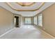 Spacious main bedroom with a decorative tray ceiling, ceiling fan, and large windows at 4845 Dartford Dr, Powder Springs, GA 30127
