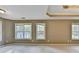 Spacious main bedroom with carpet, neutral walls, ceiling fan, and plenty of natural light from the many windows at 4845 Dartford Dr, Powder Springs, GA 30127
