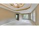 Spacious main bedroom with a decorative tray ceiling, ceiling fan, and large windows at 4845 Dartford Dr, Powder Springs, GA 30127