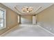 Spacious main bedroom with a decorative tray ceiling, ceiling fan, and large windows at 4845 Dartford Dr, Powder Springs, GA 30127