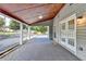 Covered patio with brick base, ceiling fan, and view of landscaped backyard, ideal for relaxation at 4845 Dartford Dr, Powder Springs, GA 30127