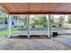 Inviting covered patio with brick flooring and view of the landscaped backyard and detached structure at 4845 Dartford Dr, Powder Springs, GA 30127