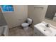 Bathroom featuring a vanity with a sink, a toilet, and a window, providing essential amenities in a compact space at 4927 Millstone Walk, Stone Mountain, GA 30088
