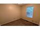 Bedroom featuring neutral walls, carpet floors, and a window providing natural light, creating a comfortable and inviting space at 4927 Millstone Walk, Stone Mountain, GA 30088