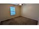 Bedroom featuring neutral walls, carpet floors, and a window providing natural light, creating a peaceful and airy atmosphere at 4927 Millstone Walk, Stone Mountain, GA 30088