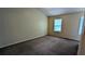 Spacious bedroom with neutral walls, carpet floors, and two windows that provide natural light, creating a comfortable retreat at 4927 Millstone Walk, Stone Mountain, GA 30088