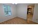 Cozy dining room with hardwood floors, a window for natural light, and kitchen access at 4927 Millstone Walk, Stone Mountain, GA 30088