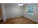 Inviting dining room with a chandelier, hardwood floors, and ample natural light from the window at 4927 Millstone Walk, Stone Mountain, GA 30088