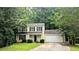 Charming two-story home with a well-manicured lawn, mature trees, and a two-car garage at 4927 Millstone Walk, Stone Mountain, GA 30088