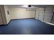 A spacious garage with blue painted floors and ample space for vehicles and storage at 4927 Millstone Walk, Stone Mountain, GA 30088