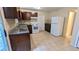 Functional kitchen with tile floors, white appliances, and ample counter space at 4927 Millstone Walk, Stone Mountain, GA 30088