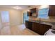 Modern kitchen with tile floors, dark wood cabinets, and a sliding door to the backyard at 4927 Millstone Walk, Stone Mountain, GA 30088