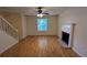 Spacious living room featuring hardwood floors, a fireplace, and a staircase leading upstairs at 4927 Millstone Walk, Stone Mountain, GA 30088