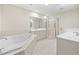 Bathroom featuring double sinks, a large soaking tub, and walk-in shower at 50 Biscayne Nw Dr # 2113, Atlanta, GA 30309