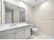 Bathroom boasts a wide mirror, double sink vanity, white cabinets, and tiled floors at 50 Biscayne Nw Dr # 2113, Atlanta, GA 30309