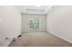 Comfortable bedroom features a tray ceiling and large window with natural light and neutral carpeting at 50 Biscayne Nw Dr # 2113, Atlanta, GA 30309