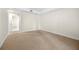 Bright bedroom boasts neutral carpet, cream walls, and natural light from an open doorway to the ensuite bathroom at 50 Biscayne Nw Dr # 2113, Atlanta, GA 30309