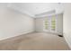 Bedroom featuring a tray ceiling and balcony access at 50 Biscayne Nw Dr # 2113, Atlanta, GA 30309