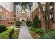 Beautiful exterior of brick apartment building with manicured landscaping and courtyard entryway at 50 Biscayne Nw Dr # 2113, Atlanta, GA 30309