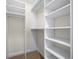 Walk-in closet with installed white shelves and carpeted floor at 50 Biscayne Nw Dr # 2113, Atlanta, GA 30309