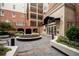 Stunning courtyard with benches, stone tiles, manicured landscaping, and building facade at 50 Biscayne Nw Dr # 2113, Atlanta, GA 30309