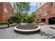 Beautiful courtyard featuring a circular fountain, lush greenery, and seating areas for relaxation at 50 Biscayne Nw Dr # 2113, Atlanta, GA 30309