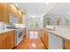Modern kitchen boasts wood cabinets and leads to a sunny dining area with window views at 50 Biscayne Nw Dr # 2113, Atlanta, GA 30309