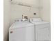 A cozy laundry room with a white washer and dryer at 50 Biscayne Nw Dr # 2113, Atlanta, GA 30309