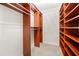 Spacious walk-in closet with custom built-in shelving and carpet floor at 50 Biscayne Nw Dr # 2113, Atlanta, GA 30309