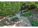 Stone steps lead to a backyard patio with a cozy fire pit and seating area at 508 Hastings Dr, Peachtree City, GA 30269