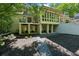 Beautifully landscaped backyard with a screened in porch, and patio under the second story balcony at 508 Hastings Dr, Peachtree City, GA 30269