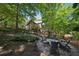 Private backyard featuring a stone patio with a fire pit and comfortable seating at 508 Hastings Dr, Peachtree City, GA 30269
