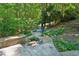 Stone steps lead to a backyard patio with a cozy fire pit and seating area at 508 Hastings Dr, Peachtree City, GA 30269