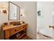 Charming bathroom with a wood vanity, a dark sink, and beadboard walls exudes rustic elegance at 508 Hastings Dr, Peachtree City, GA 30269