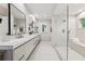 Bright bathroom featuring a glass shower with bench, double vanity with drawers, and view to the outdoors through a window at 508 Hastings Dr, Peachtree City, GA 30269