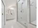 Clean, tiled bathroom features frameless shower, sink with vanity, and storage cabinets at 508 Hastings Dr, Peachtree City, GA 30269