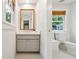 Well-lit bathroom with a light gray vanity cabinet and a framed mirror at 508 Hastings Dr, Peachtree City, GA 30269