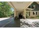 Long driveway leads to a covered carport offering a shaded parking area at 508 Hastings Dr, Peachtree City, GA 30269