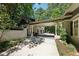 Long driveway leads to a covered carport and garage framed by trees and landscaping at 508 Hastings Dr, Peachtree City, GA 30269