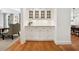 Cozy dining area featuring a bar with glass doors and hardwood floors at 508 Hastings Dr, Peachtree City, GA 30269