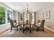Bright dining room with large windows, complemented by a round table and stylish chandelier for a cozy feel at 508 Hastings Dr, Peachtree City, GA 30269