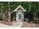 Charming dog house with a fenced-in yard, nestled among the trees and greenery of the backyard at 508 Hastings Dr, Peachtree City, GA 30269
