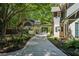 View of the driveway to the covered parking and guest house, enveloped in greenery at 508 Hastings Dr, Peachtree City, GA 30269