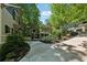View of homes from the driveway, showcasing beautiful landscaping and mature trees at 508 Hastings Dr, Peachtree City, GA 30269