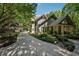 Charming two-story home with lush landscaping and a welcoming front porch, nestled amongst mature trees at 508 Hastings Dr, Peachtree City, GA 30269