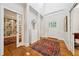 Bright foyer with hardwood floors, open doorway to the library, and decorative sculpture at 508 Hastings Dr, Peachtree City, GA 30269